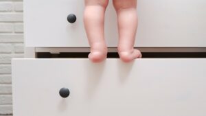 Child climbing dresser causing tip-over